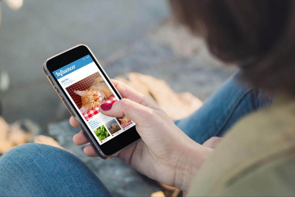 social media branding: woman looking at social media on her phone